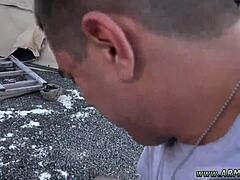 Young army boy receives blowjob in group outdoor setting